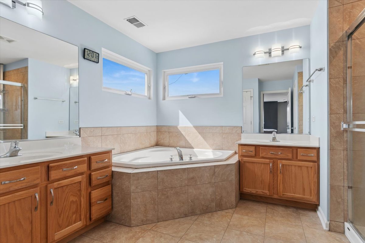 724 North Misty Ridge Drive Romeoville, IL 60446 - Photo 13 of 26 a view of a bathroom sink and mirror