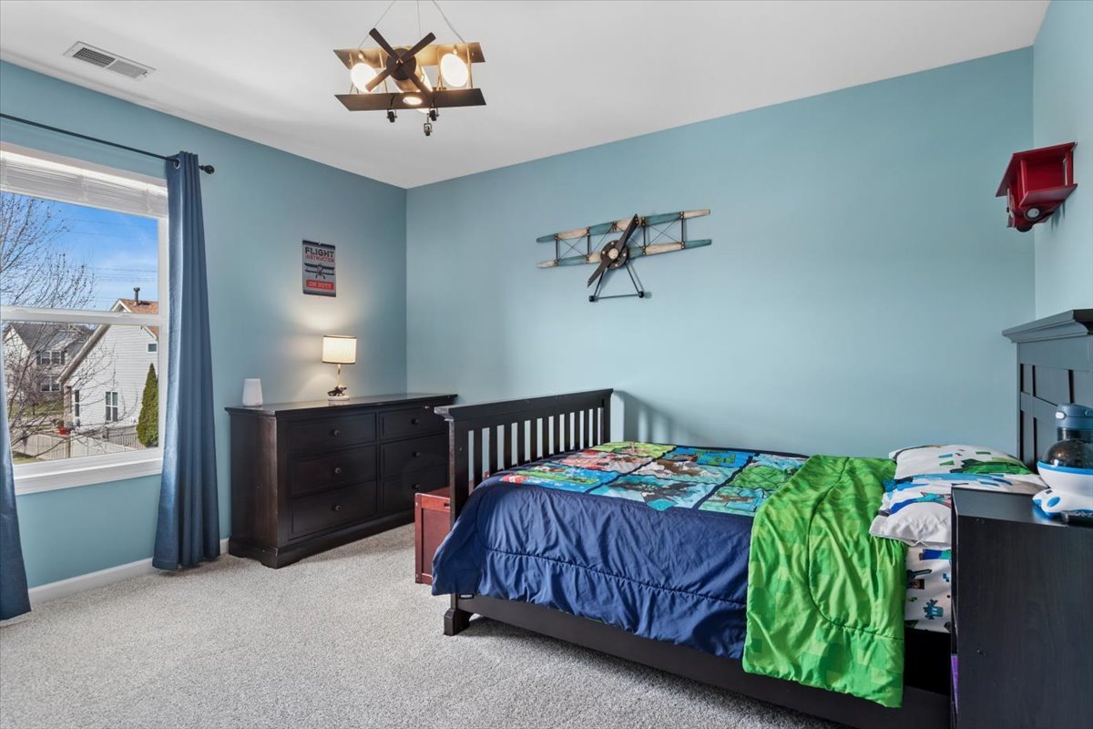 724 North Misty Ridge Drive Romeoville, IL 60446 - Photo 15 of 26 a bedroom with a bed and a window