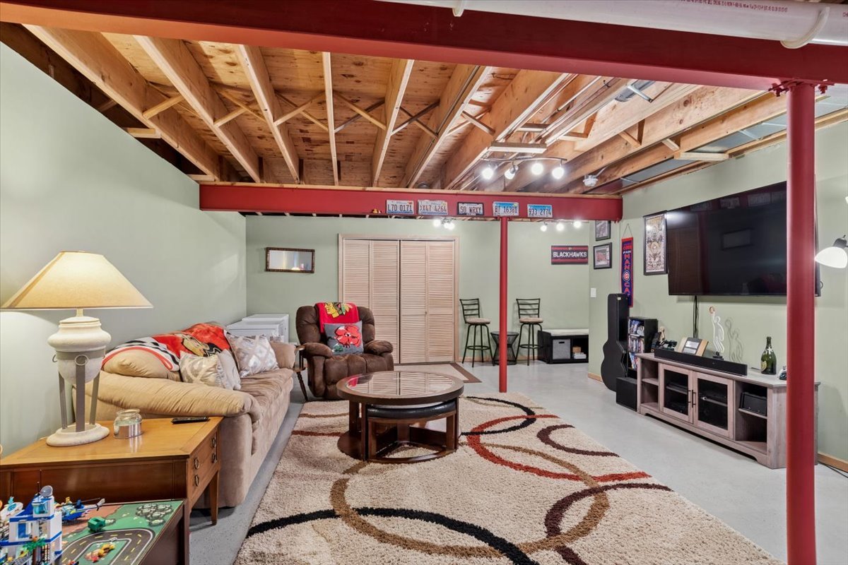 724 North Misty Ridge Drive Romeoville, IL 60446 - Photo 19 of 26 a living room with furniture and a flat screen tv