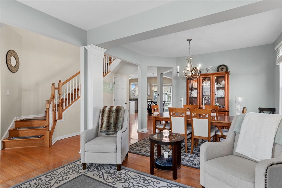 724 North Misty Ridge Drive Romeoville, IL 60446 - Photo 2 of 26 a living room with furniture and a chandelier