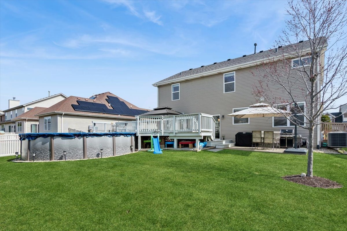 724 North Misty Ridge Drive Romeoville, IL 60446 - Photo 21 of 26 a view of a big house with a big yard and large trees