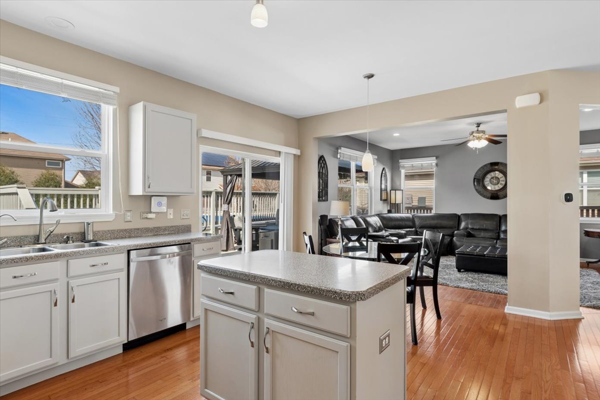 724 North Misty Ridge Drive Romeoville, IL 60446 - Photo 5 of 26 a open kitchen with stainless steel appliances granite countertop a stove and cabinets