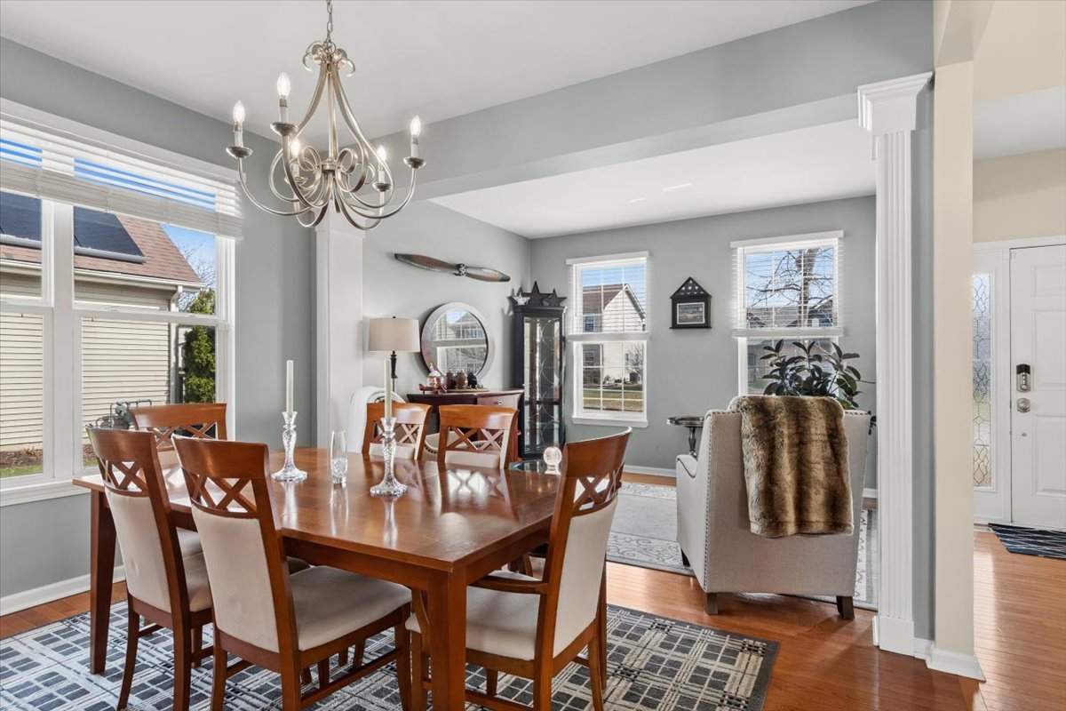 724 North Misty Ridge Drive Romeoville, IL 60446 - Photo 9 of 26 a view of a dining room with furniture and chandelier