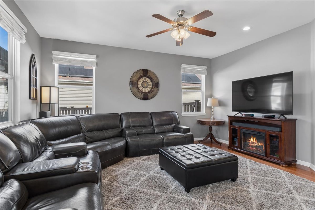 724 North Misty Ridge Drive Romeoville, IL 60446 - Photo 10 of 26 a living room with furniture a flat screen tv and a fireplace