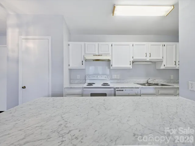 a kitchen with sink cabinets and stove