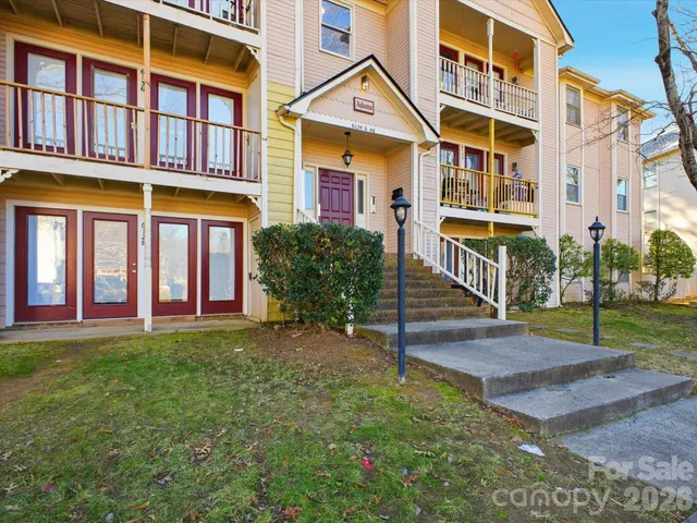 a front view of a brick building with a yard