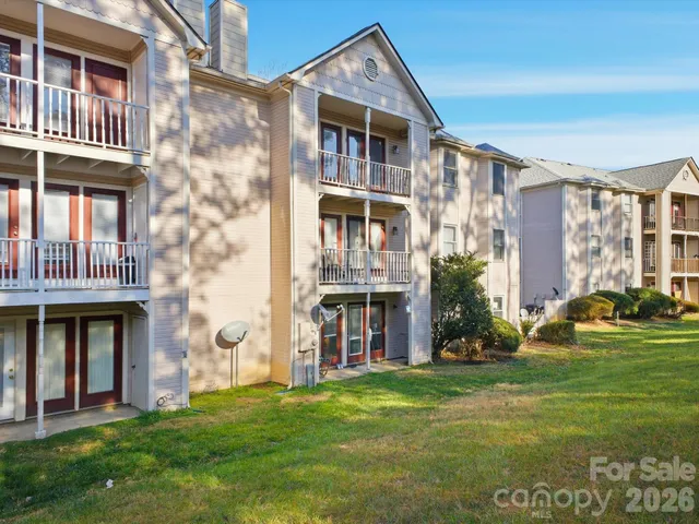 a front view of a building with a garden