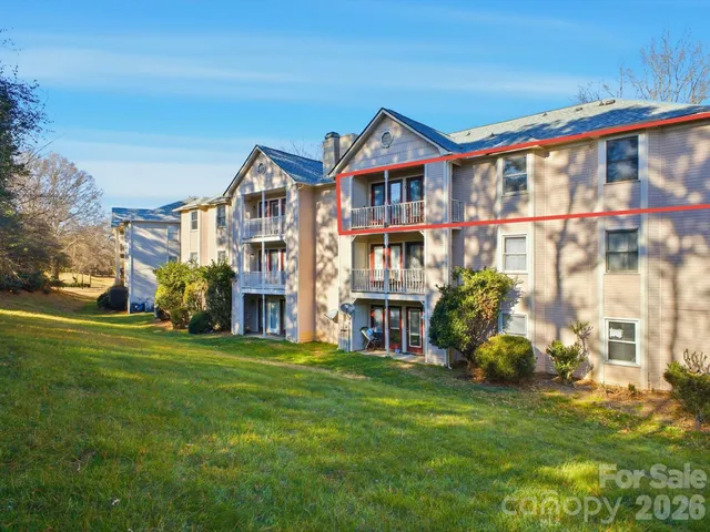 a front view of a residential apartment building with a yard