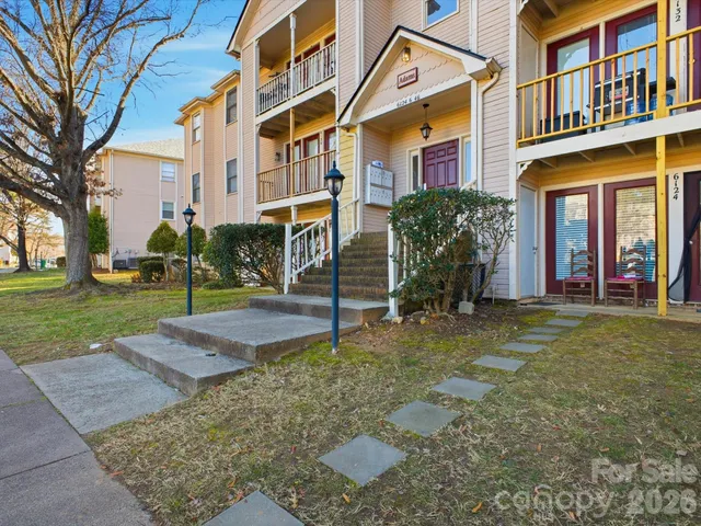 a view of a building with a yard