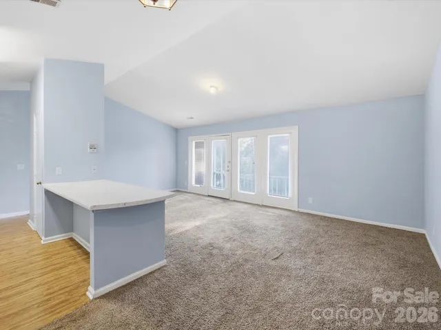 a large white kitchen with a sink and cabinets