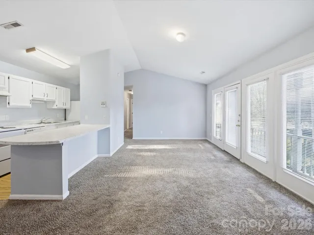 a view of a kitchen with a sink and cabinets