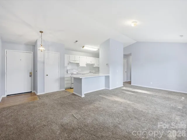 a view of a kitchen with a sink and cabinets