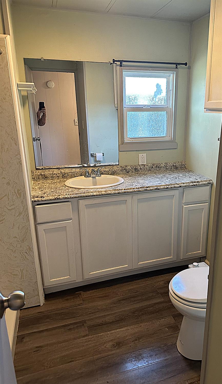 13955 West Walnut Grove Road, Unit 16 Walnut Grove, CA 95690 - Photo 14 of 18 a bathroom with a granite countertop toilet sink and mirror
