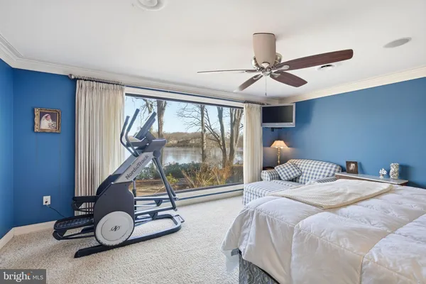 a bedroom with a bed and gym equipment