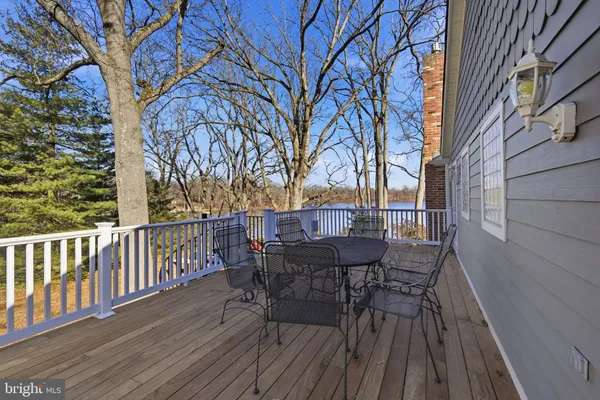 a view of a deck with furniture and trees