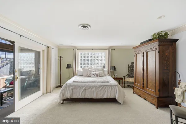 a bedroom with a bed table and a dresser