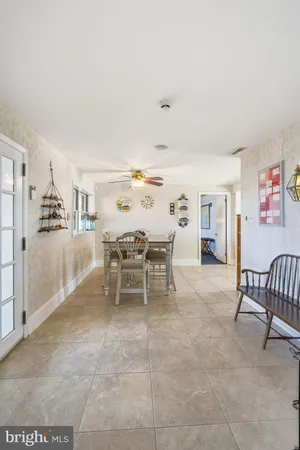 a dining room with furniture and a kitchen view