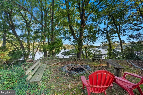 a backyard of a house with barbeque oven table and chairs