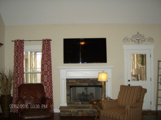 121 Laurel Ridge Forsyth, GA 31029 - Photo 3 of 19 a living room with furniture a flat screen tv and a fireplace