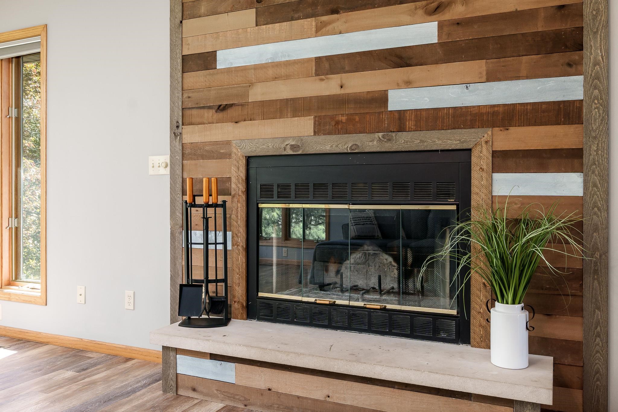 10249 Atwood Road Roscoe, IL 61073 - Photo 11 of 58 a living room with a potted plant and a fireplace