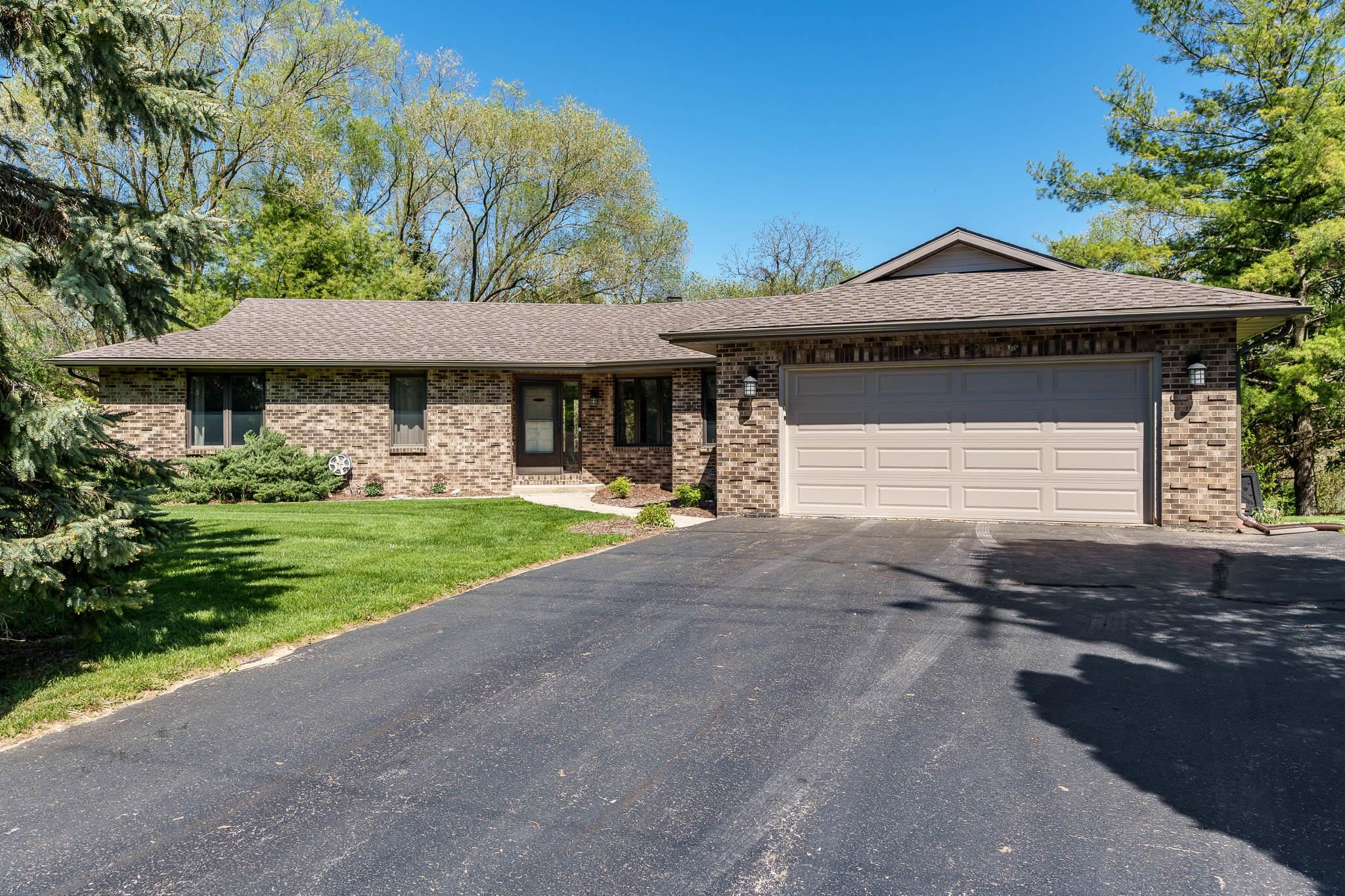 10249 Atwood Road Roscoe, IL 61073 - Photo 2 of 58 a front view of a house with garden