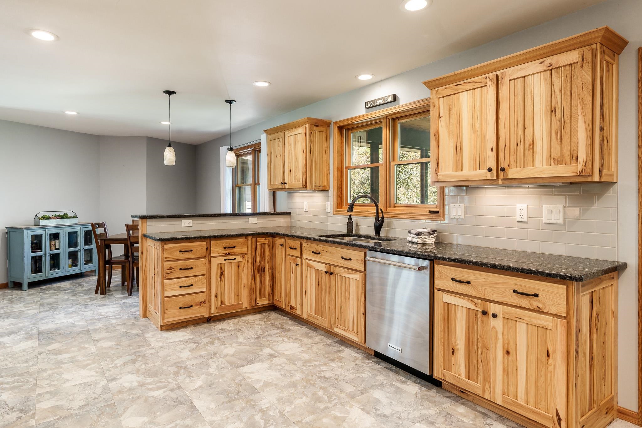 10249 Atwood Road Roscoe, IL 61073 - Photo 22 of 58 a kitchen with stainless steel appliances granite countertop a stove and a sink