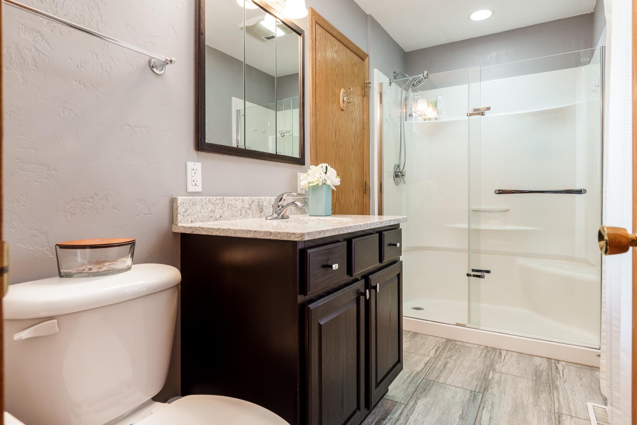 10249 Atwood Road Roscoe, IL 61073 - Photo 28 of 58 a bathroom with a sink toilet vanity and shower
