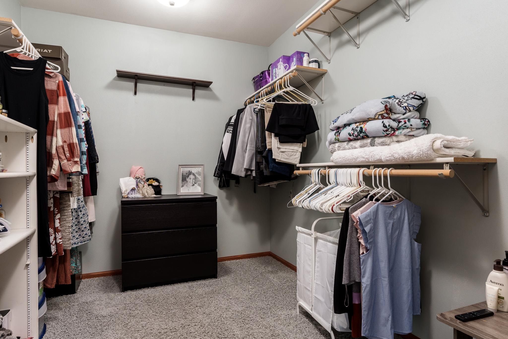 10249 Atwood Road Roscoe, IL 61073 - Photo 29 of 58 a view of walk in closet with clothes and shoes