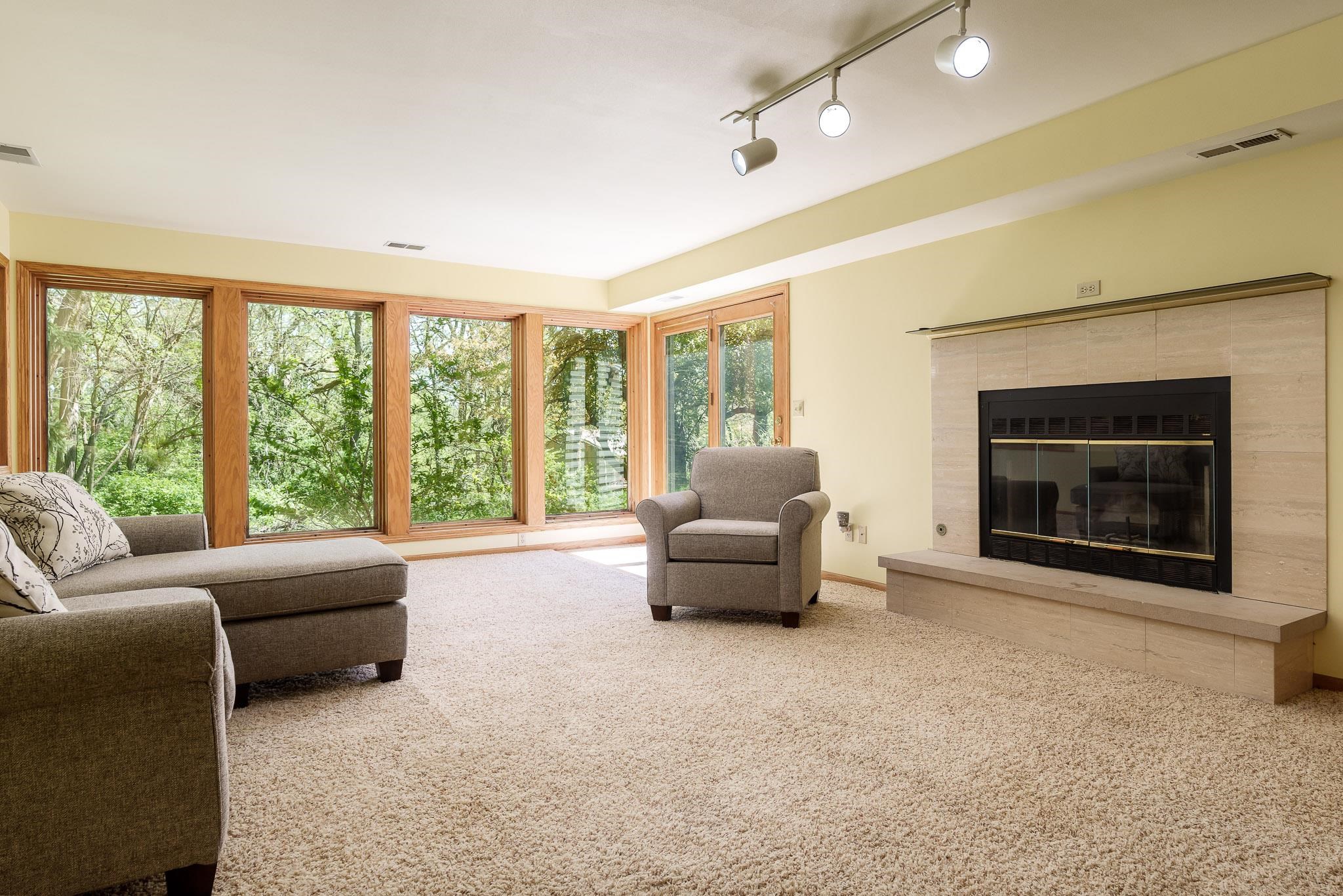 10249 Atwood Road Roscoe, IL 61073 - Photo 32 of 58 a living room with furniture and a fireplace