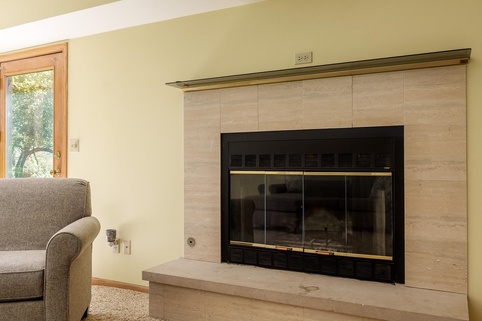 10249 Atwood Road Roscoe, IL 61073 - Photo 34 of 58 a living room with a couch and a fireplace