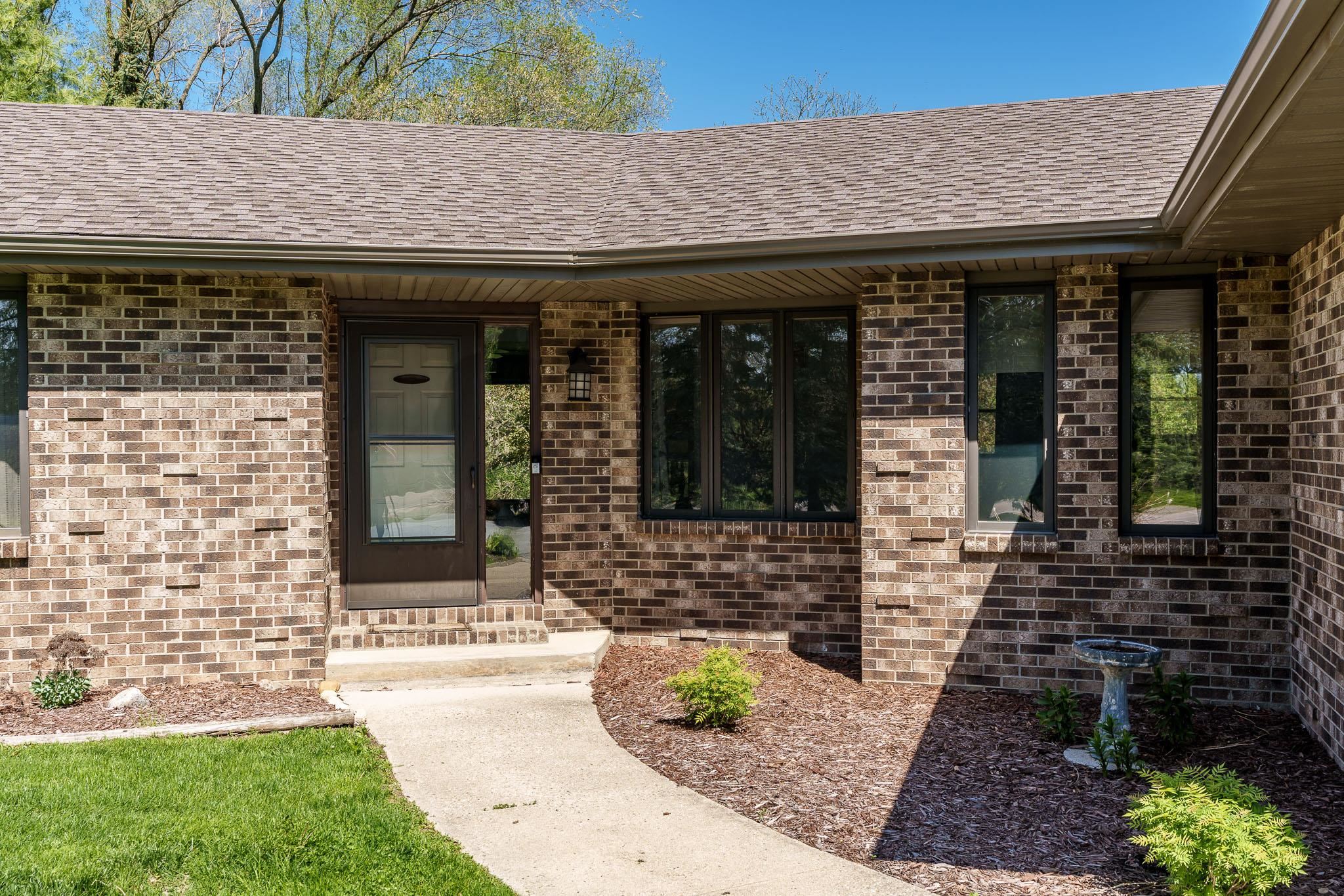 10249 Atwood Road Roscoe, IL 61073 - Photo 4 of 58 a front view of a house with a garden