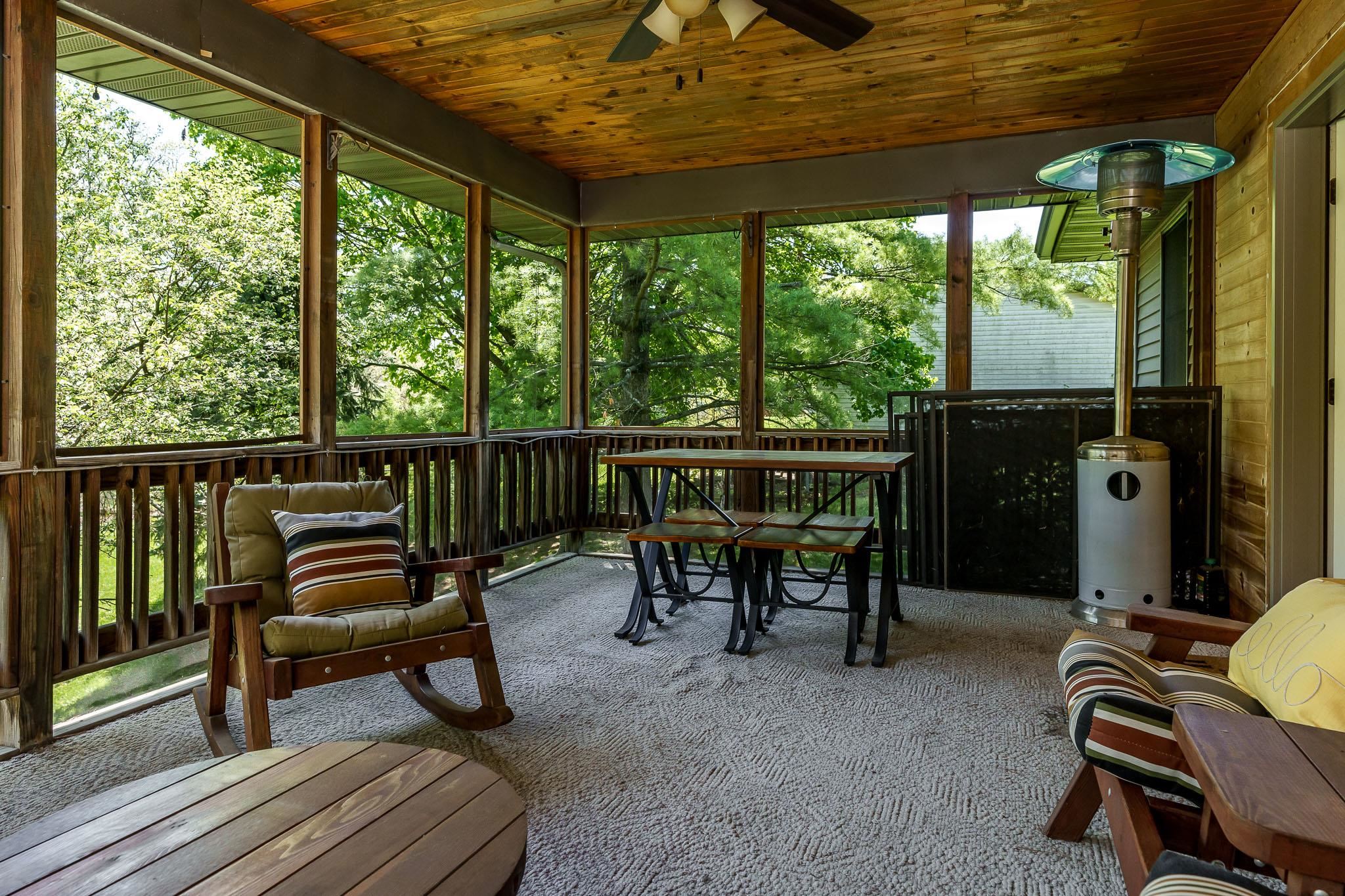 10249 Atwood Road Roscoe, IL 61073 - Photo 47 of 58 a view of a porch with furniture and a yard