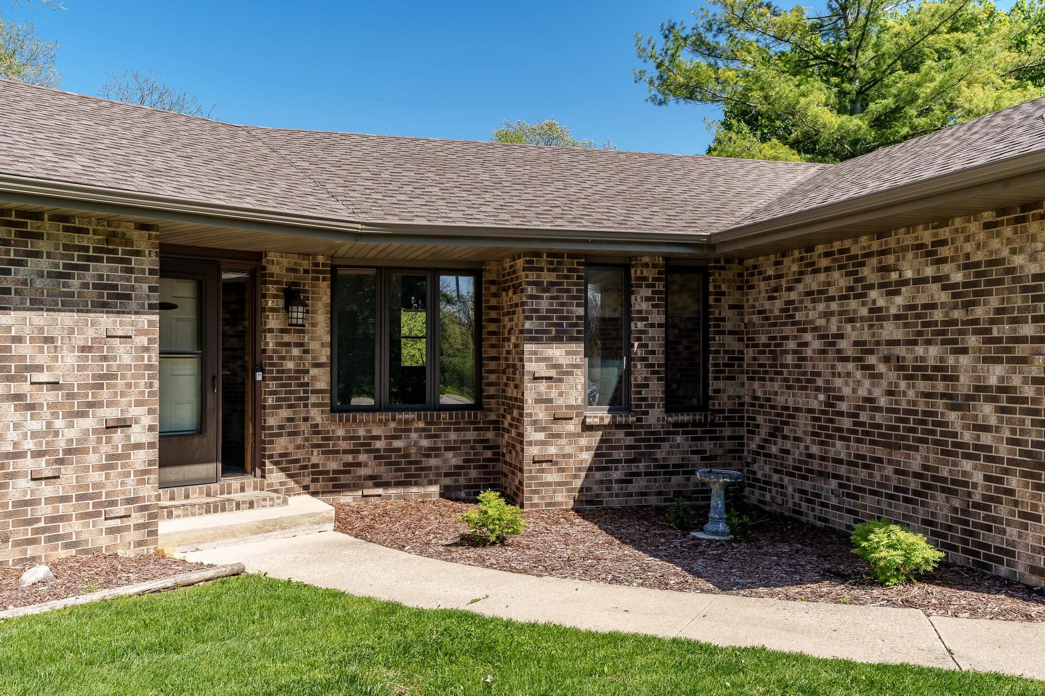 10249 Atwood Road Roscoe, IL 61073 - Photo 5 of 58 a front view of a house with garden