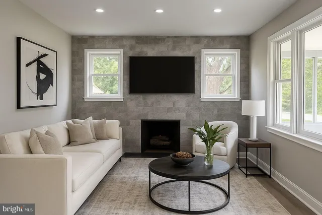 a living room with furniture a flat screen tv and a fireplace