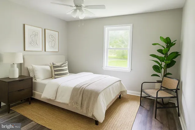 a bedroom with a bed and a potted plant