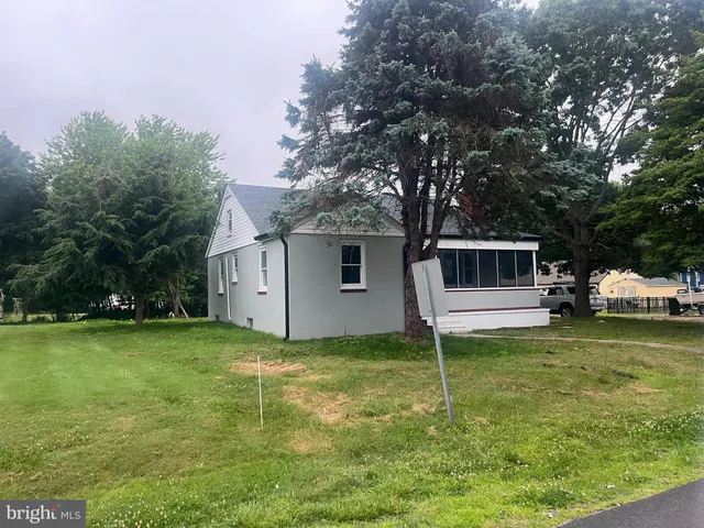 a white house that has a tree in front of it