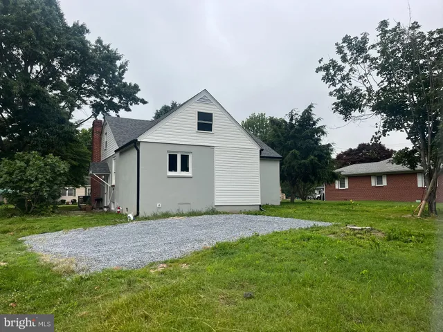 a front view of house with yard and trees