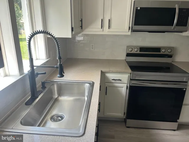 a kitchen with a stove and a microwave