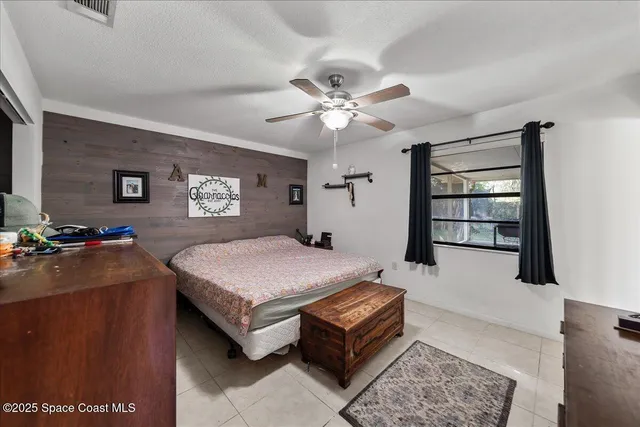 a bedroom with a bed dresser and a window