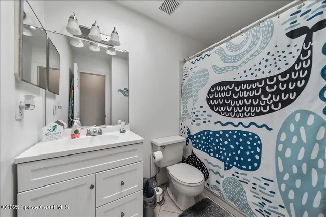 a bathroom with a sink mirror vanity and toilet