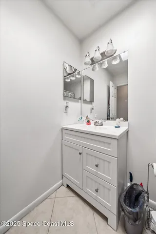 a bathroom with a sink vanity and mirror