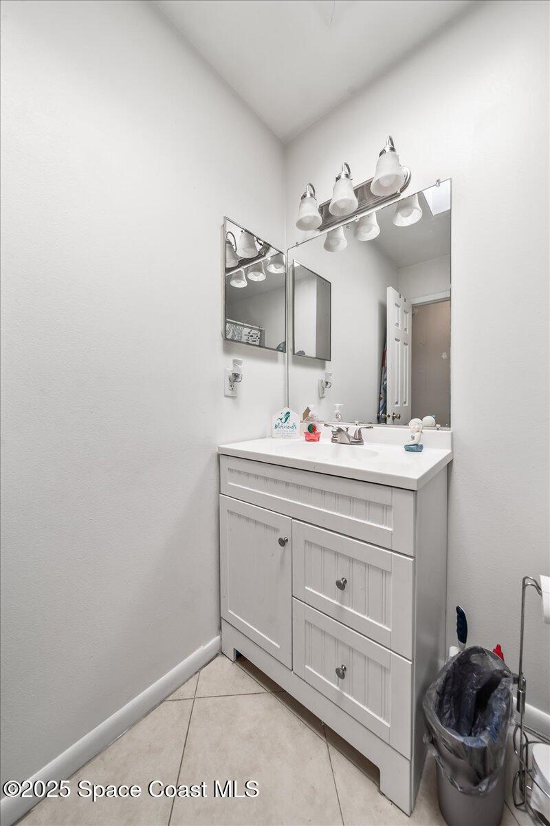 5575 Curtis Boulevard Cocoa, FL 32927 - Photo 18 of 25 a bathroom with a sink vanity and mirror