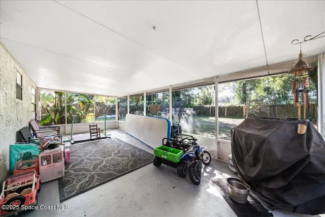 a living room with furniture a floor to ceiling window and floor to ceiling window