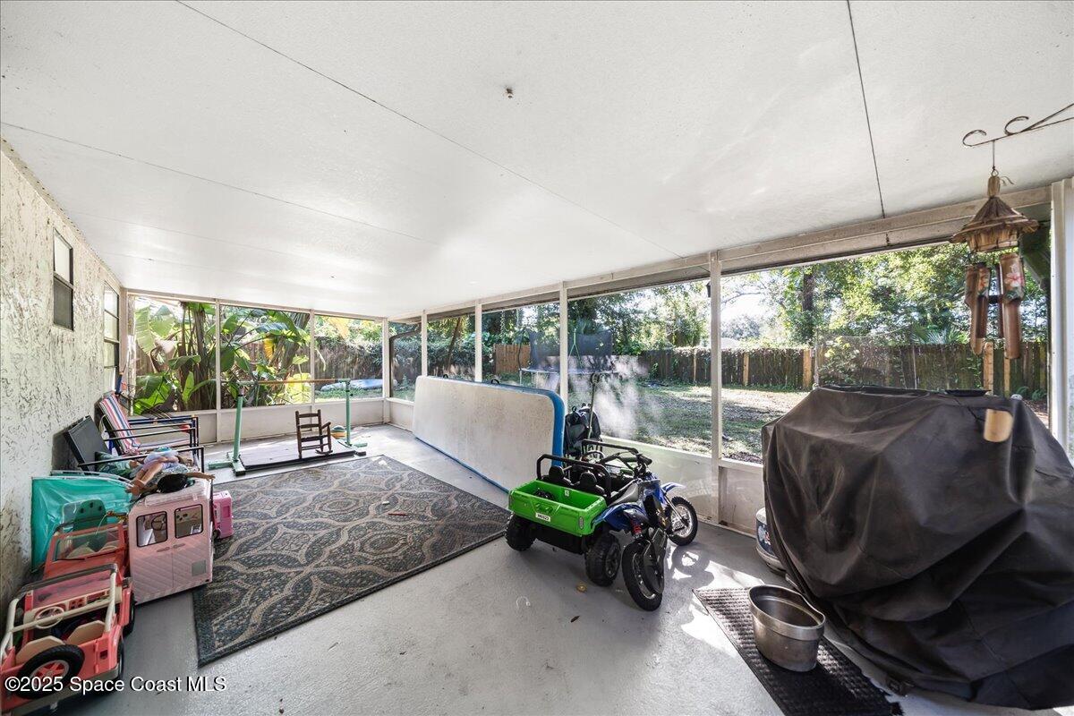 5575 Curtis Boulevard Cocoa, FL 32927 - Photo 20 of 25 a living room with furniture a floor to ceiling window and floor to ceiling window