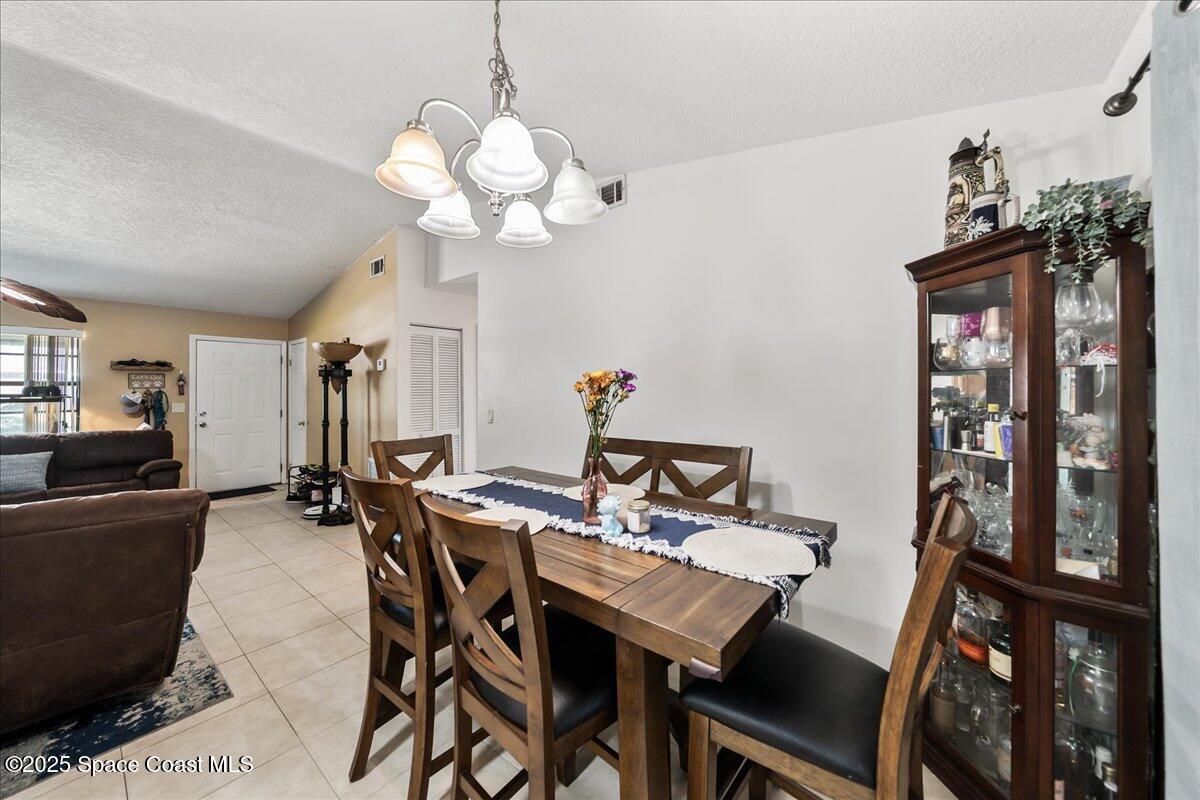 5575 Curtis Boulevard Cocoa, FL 32927 - Photo 6 of 25 a view of a dining room with furniture and chandelier