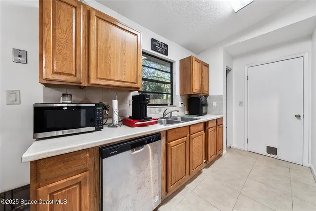 a kitchen with stainless steel appliances a sink stove and cabinets