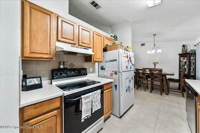 a kitchen with a stove refrigerator and cabinets