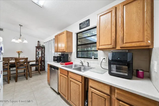 a kitchen with stainless steel appliances granite countertop sink cabinets and window