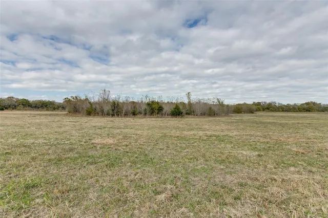 a view of a lake with houses in the back