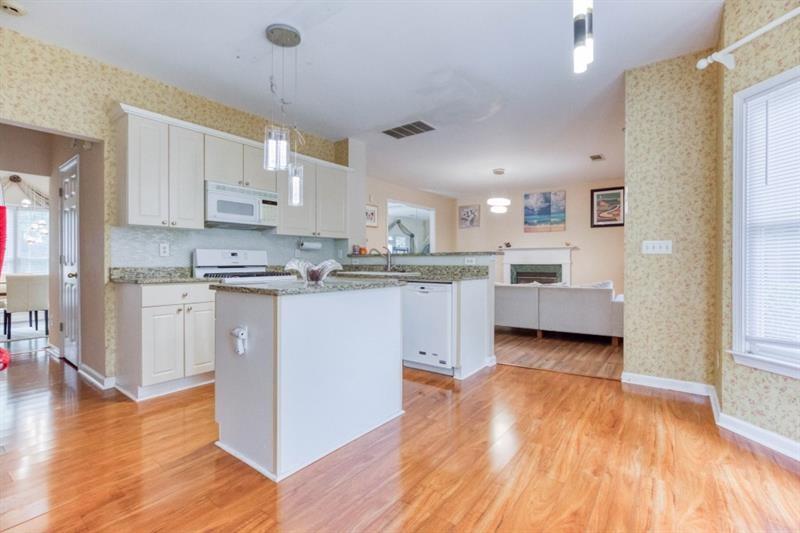 1008 Post Horn Run Lawrenceville, GA 30045 - Photo 11 of 64 a kitchen with kitchen island a sink stainless steel appliances and cabinets